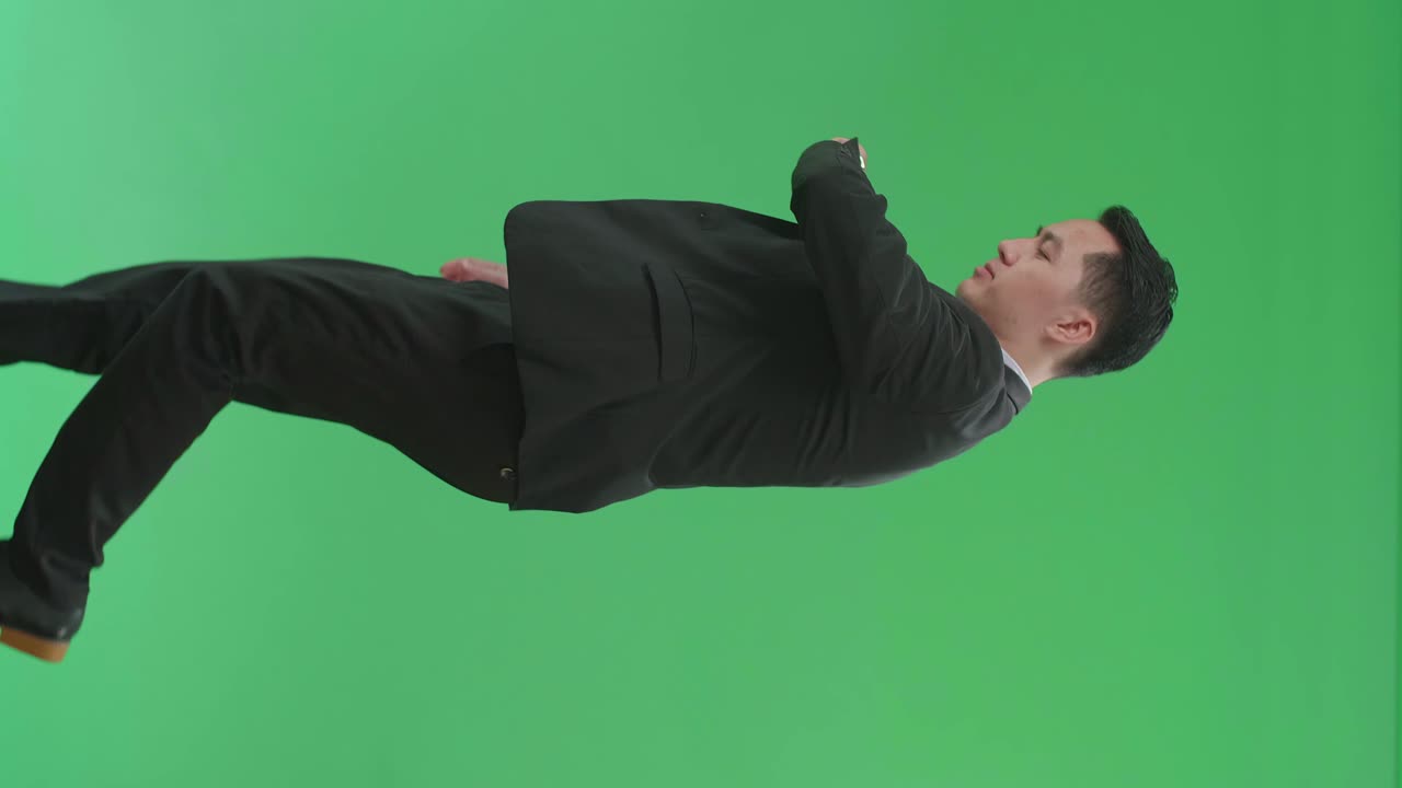 Side View Of Asian Business Man Walking And Looking At Watch On Green Screen Chroma Key