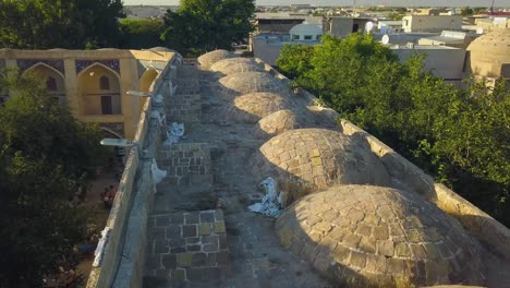 Close-Drone-shot-of-Nodir-Devonbegi-Madrasah-in-Bukhara,-Uzbekistan