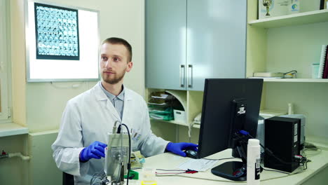 doctor talking to patient in office. male doctor in lab coat sitting at desk in clinic