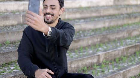 Hombre-Sonriente-Teniendo-Video-Chat-En-La-Calle