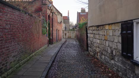 slow dolly in down old fashioned cobble street in historic city of york