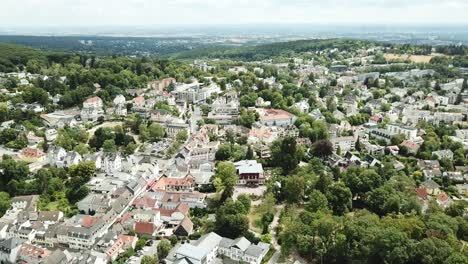 City-in-a-Valley,-Germany,-flying-over-and-tilting-up