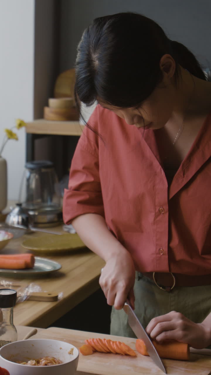 Woman Chopping Carrots for a Meal