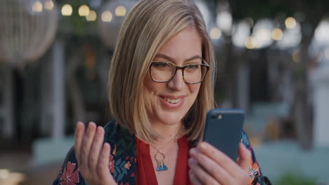 portrait-happy-young-blonde-woman-using-smartphone-video-chat-waving-enjoying-mobile-communication-in-city-long-distance-call-slow-motion