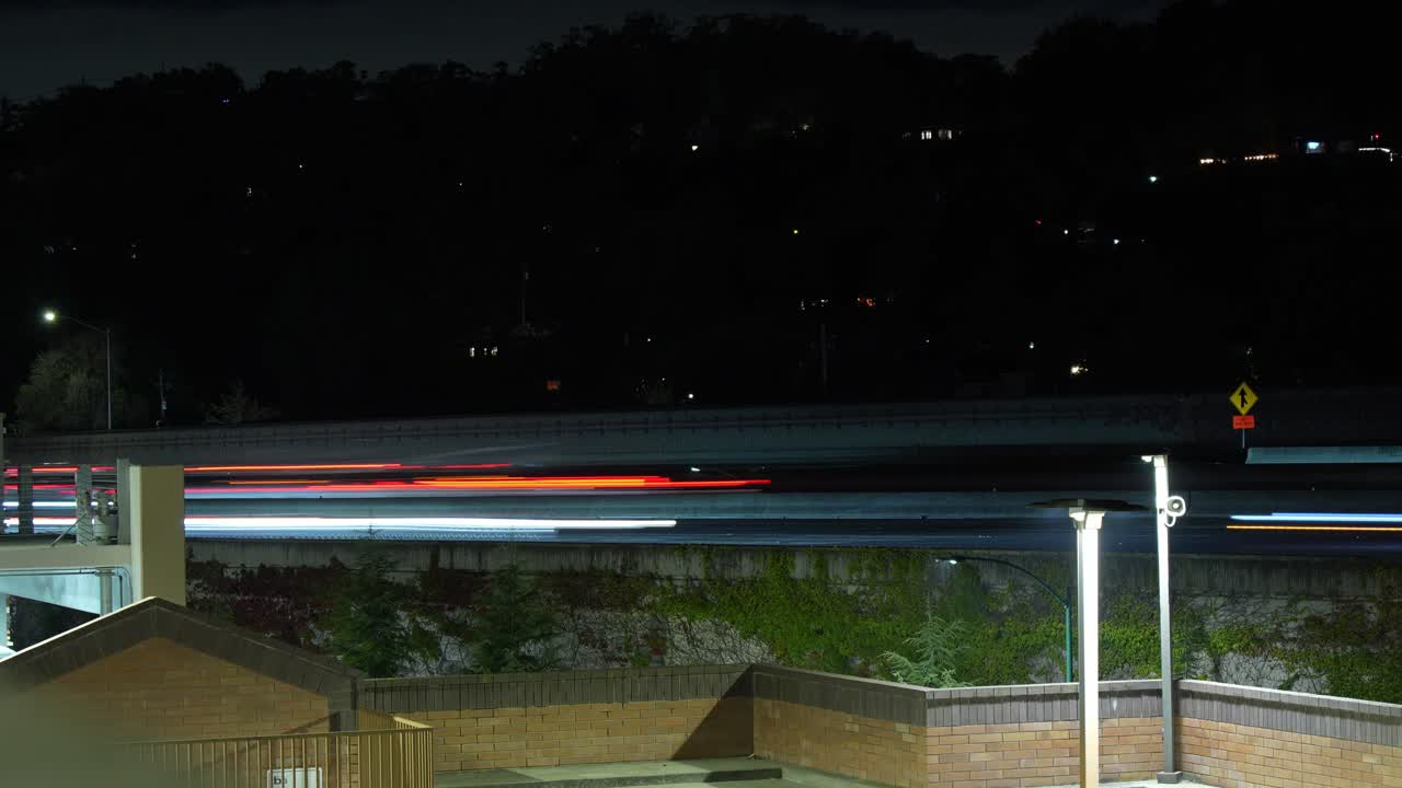Cars carve glowing paths through Walnut Creek’s highway in this elevated time-lapse view, blending motion, architecture, and dusk colors