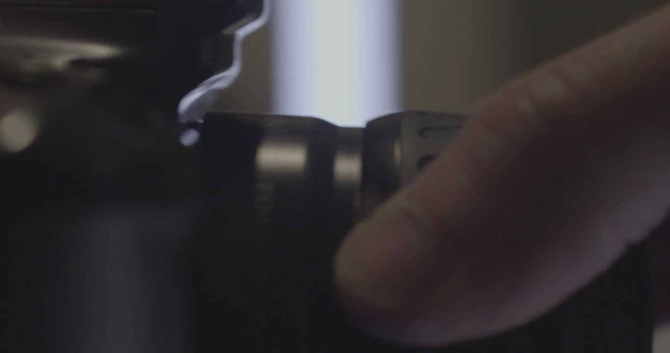 Attaching camera lens on digital camera, close up view