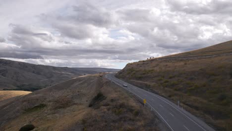 Car-driving-fast-up-alpine-road