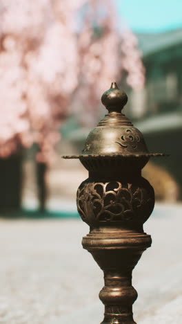 close-up of a bronze lantern in a japanese garden