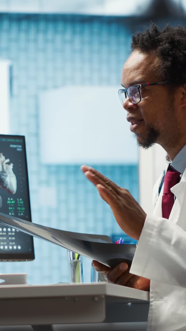 African American Doctor Examining X-ray and Heart Scan on Computer