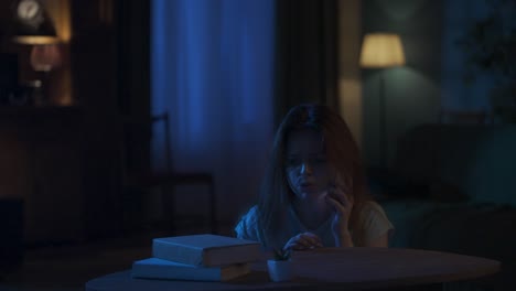 afraid young girl with baseball bat standing near the window runs to the table and calls to police - horror movie scene in the apartment creative concept. afraid young girl with baseball bat standing near the window, runs to the table and calls to police on smartphone, talking, maniac walking around