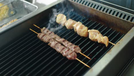 Close-up-of-grilled-meat-on-a-grill-with-flames