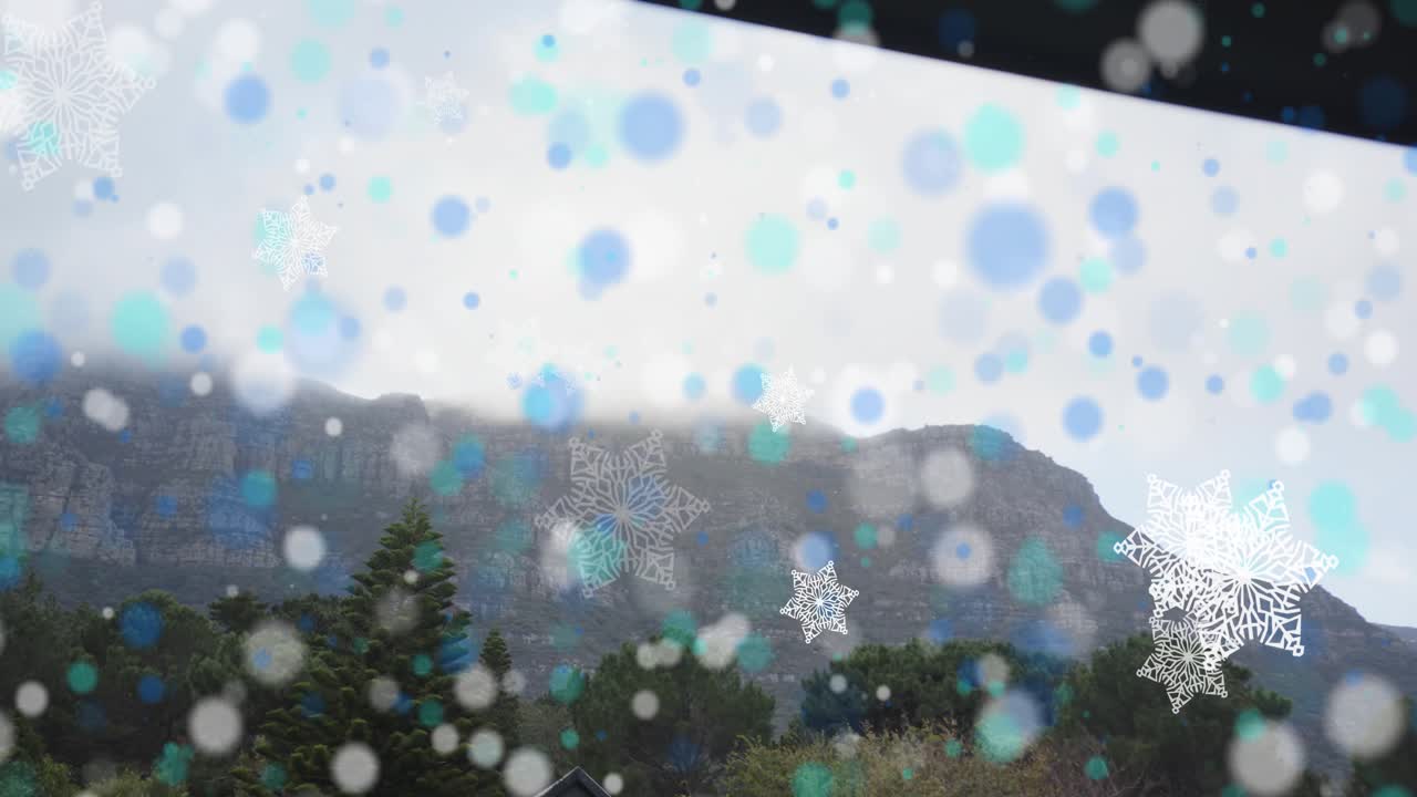 Colored dots appearing and snowflakes drifting, overlay growing across rocky ridge for winter look