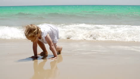 Little-girl-romping-at-the-edge-of-the-surf