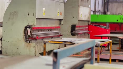 industrial machine for bending metal inside factory, handheld view