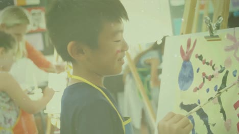 animation of lights over asian boy at art class