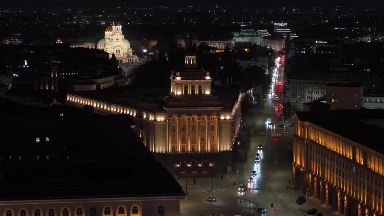 Drone reveal of Sofia’s glowing central road, capturing night traffic and the illuminated Alexander Nevsky Cathedral rising in the background