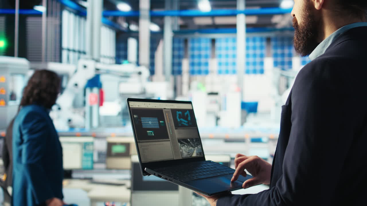 Photovoltaics factory worker analyzing data with laptop