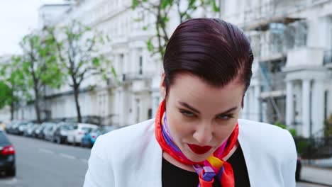 Stylish-Woman-Wearing-Scarf-Standing-On-City-Street