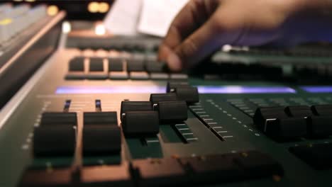 male hands using sound and light digital mixer at a concert