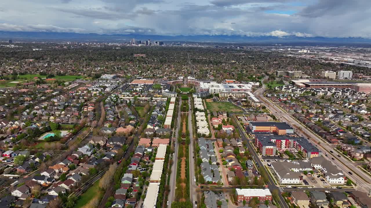 Front Range Denver Lowry Northfield Central Park Colorado aerial drone neighborhood apartment buildings sunny cloudy sky cloudy Lakewood Arvada Golden cars cityscape skyscrapers forward pan up motion