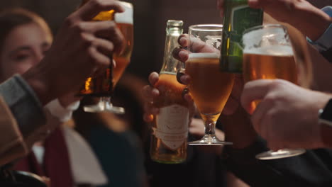 diverse group of friends making toast having fun drinking socializing hanging out in bar chatting sharing celebration enjoying evening reunion gathering