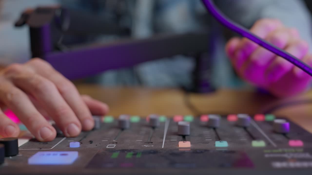 Hands adjusting knobs and sliders on a podcast or sound engineering control panel. Close-up. Precision, focus, and audio production. Podcasting, sound design, music production, or broadcasting