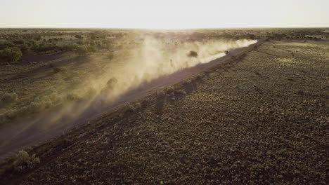 drone chasing cars into sunset over the australian desert in central western australia