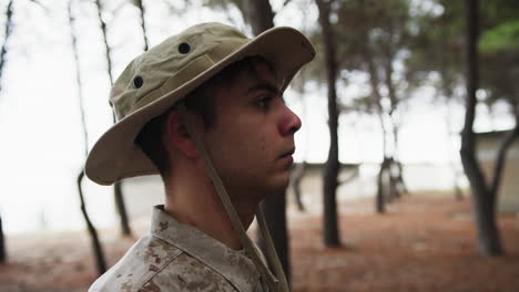 soldier stands at attention saluting the general in the woods with trees