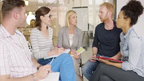 colleagues listening to bearded man