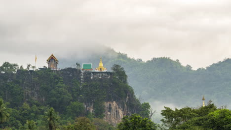 A-4K-static-time-lapse-of-a-Buddhist-pagoda-on-a-hill-with-clouds-rolling-in-the-background