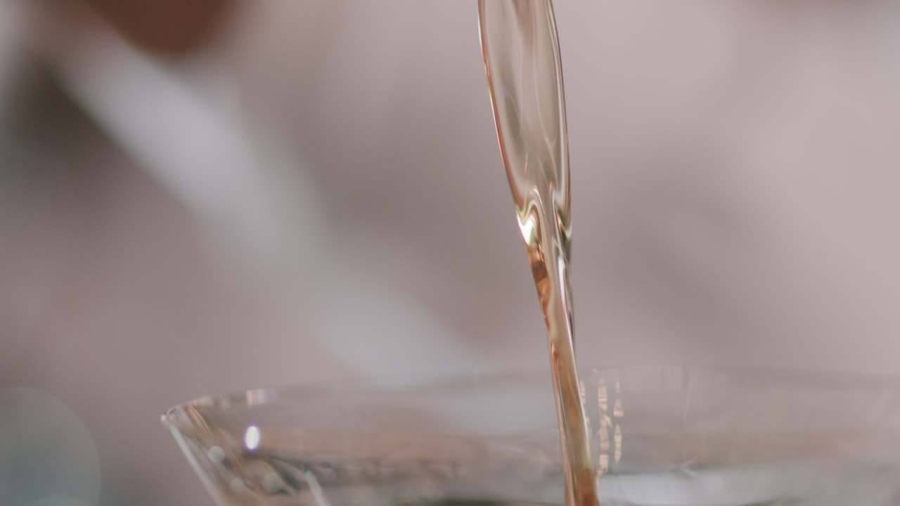 Close-up of a martini being poured, capturing the fluid fall of the liquid into the glass with style and precision.