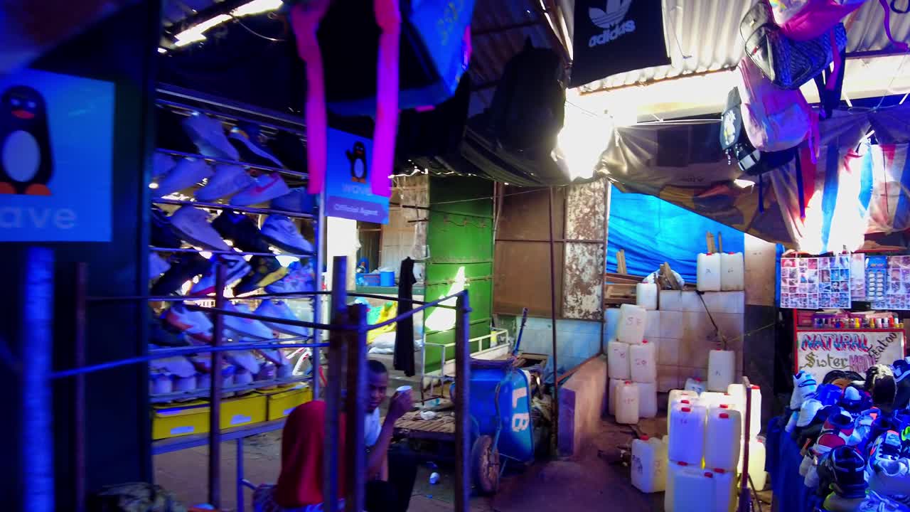 POV walk through colorful market aisles filled with vibrant textiles, vendors, and shoppers