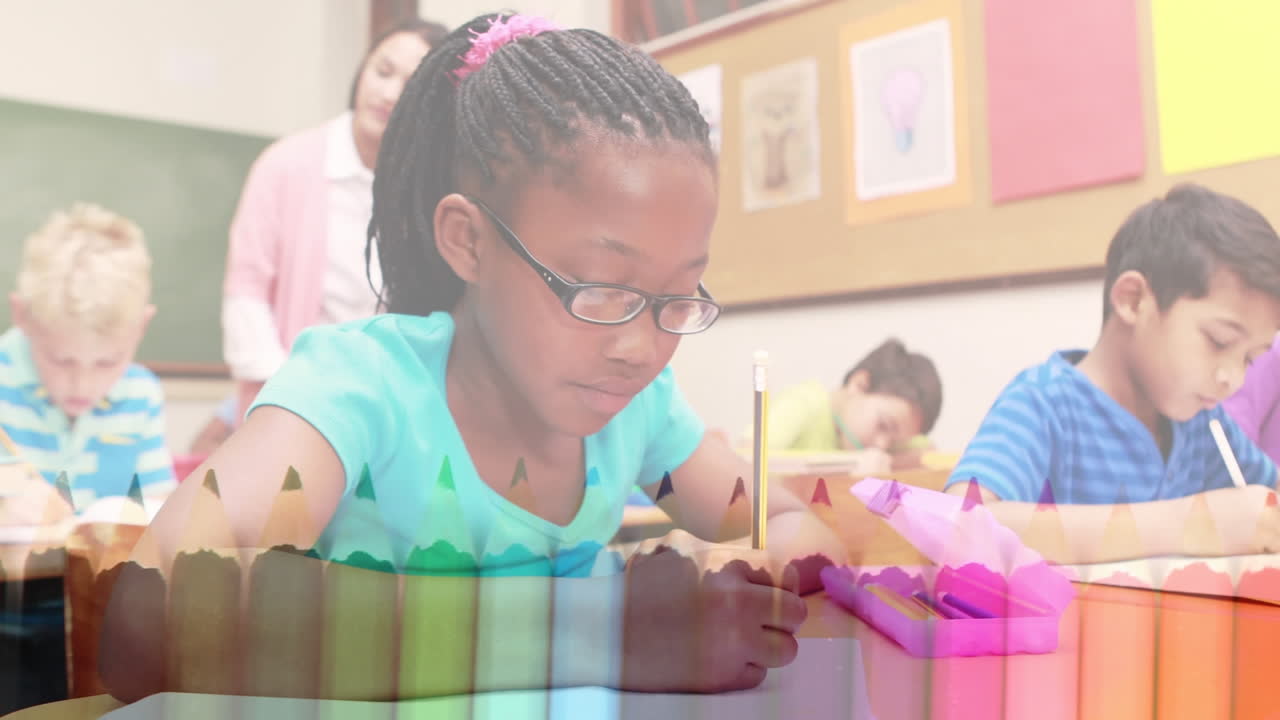 Animation of crayons over happy african american girl learning at school with diverse pupils