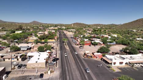 Drone-shot-following-cars-down-the-main-street-of-Cave-Creek,-Arizona