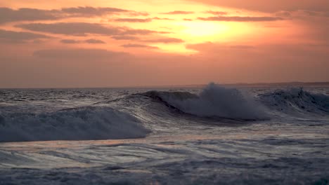 sunset hues casting a warm glow over cresting ocean waves, shot in slow motion