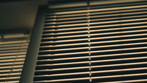 horizontal-blinds-on-window-in-dark-room-low-angle-shot
