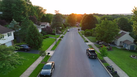 reverse drone shot of small town street in america