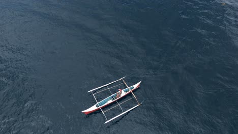 Aerial-overhead-of-fisherman-on-outrigger-with-large-fish-on-the-hook