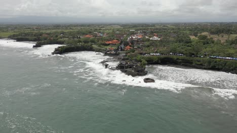 tanah lot hindu temple on rocky outcrop on rugged bali shoreline