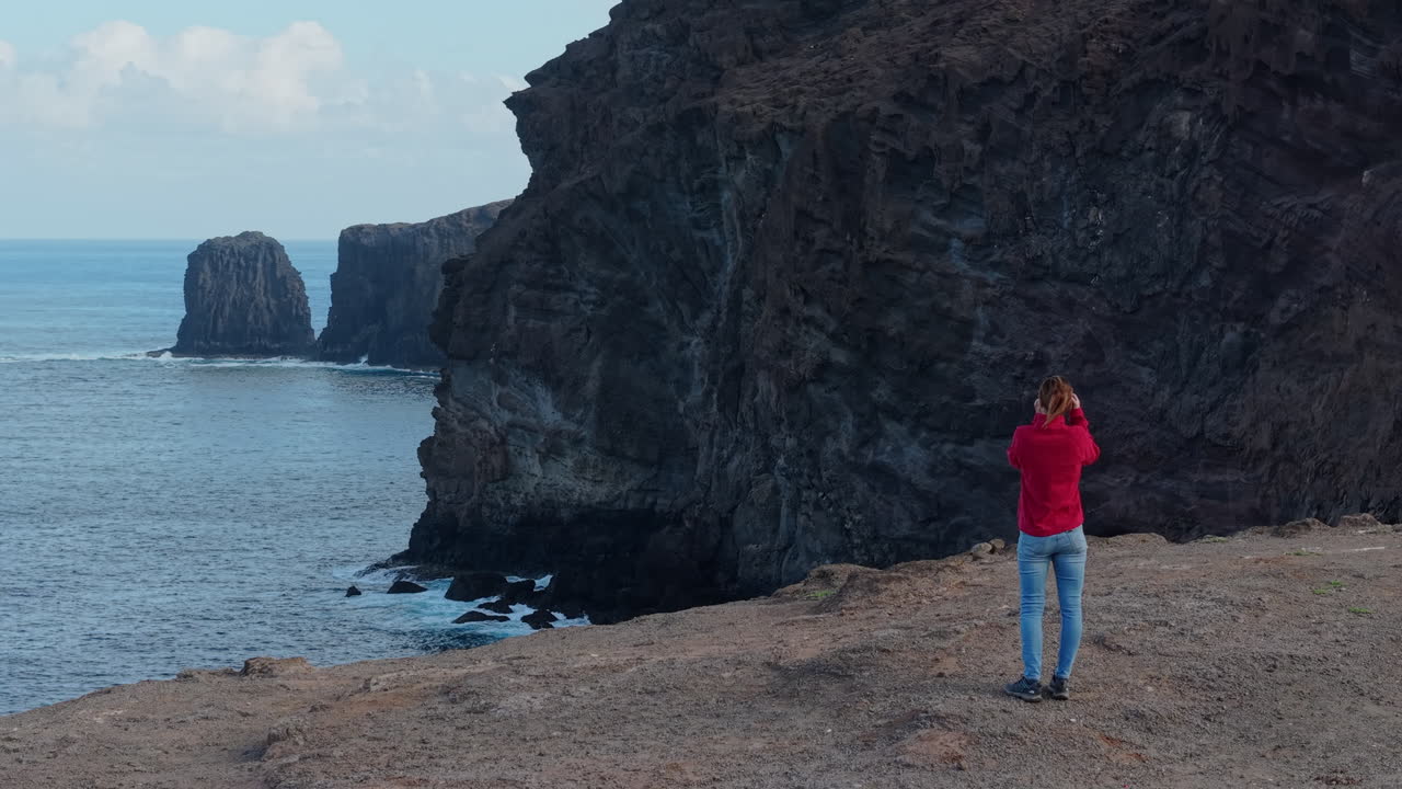 Capturing scenic coastal landscape with Roque Partido rock formation and expansive ocean views in gran canaria's rugged volcanic terrain during sunny day. Gran Canaria.