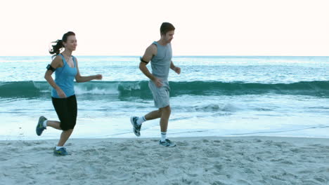 couple running on the beach