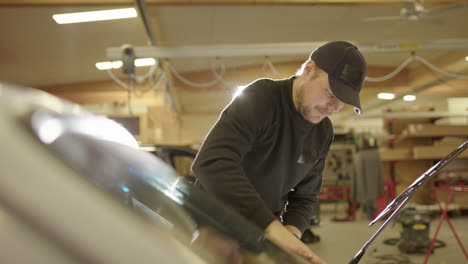 glass technicians making sure the windscreen is properly seated into seal