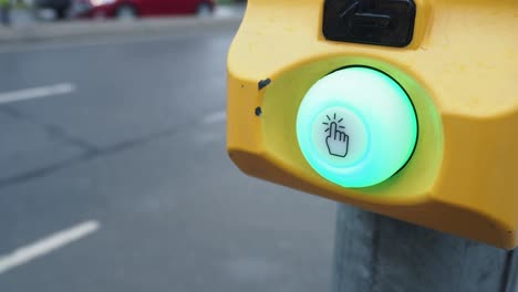 close up of a red pedestrian crossing button