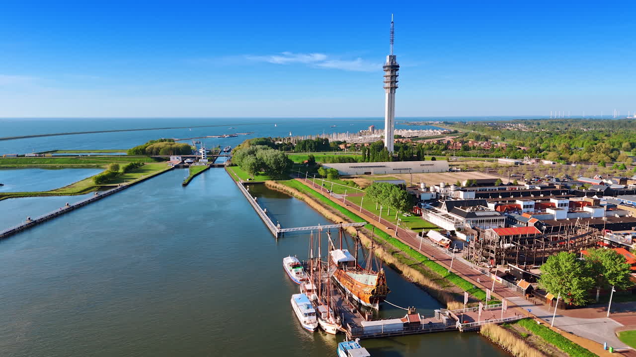 Spectacular view of lake Markermeer in Lelystad, the Netherlands. Drone flight above the ship reconstruction in Batavialand Museum.
