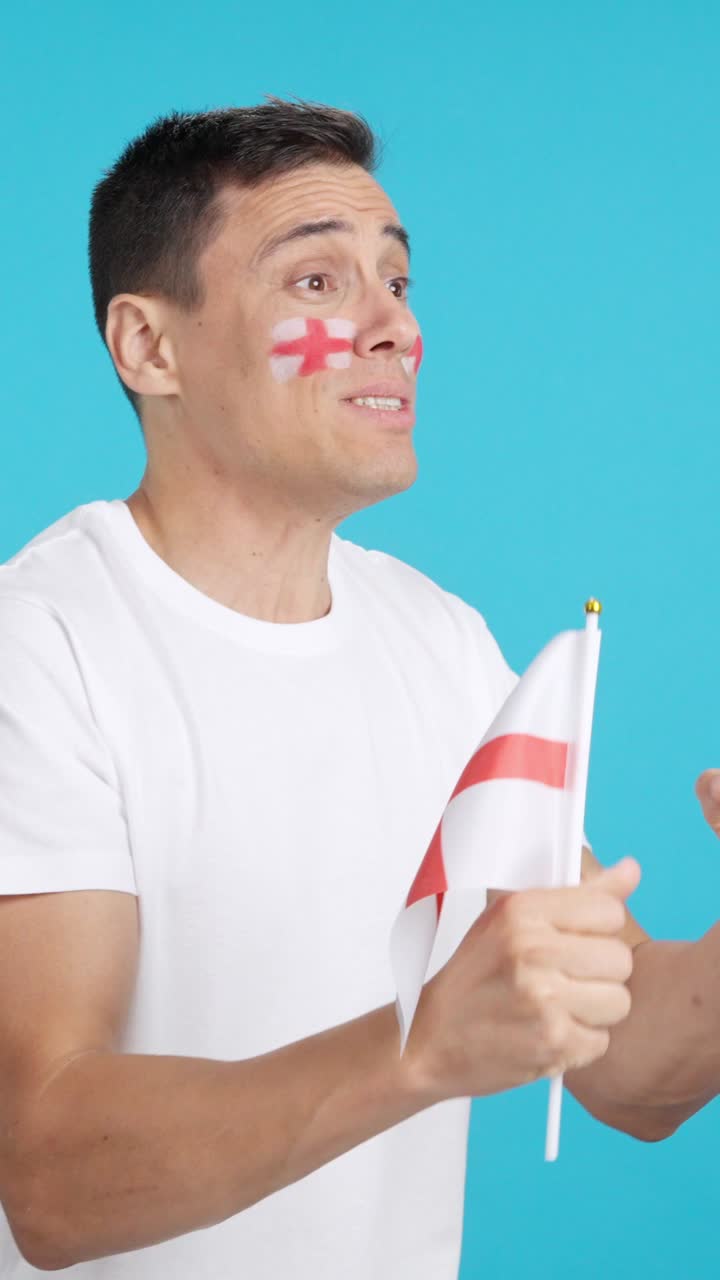 Nervous english supporter during an exciting match looking away