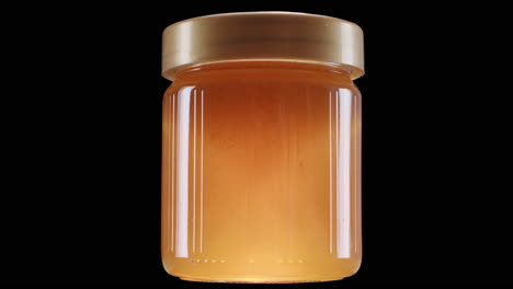 Glühendes-Honigglas-Auf-Schwarzem-Hintergrund,-Statische-Aufnahme