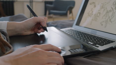 unrecognizable graphic designer drawing sketches on tablet