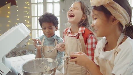 Joyous-Children-Blowing-Flour-Out-of-Spoons-on-Cooking-Masterclass