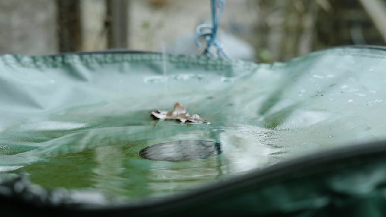 Water collection tank filling with rainwater, representing eco-friendly practices.