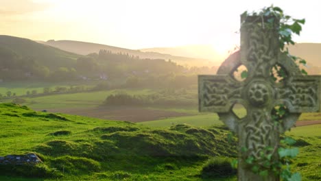 celtic cross gravestone in the scottish countryside